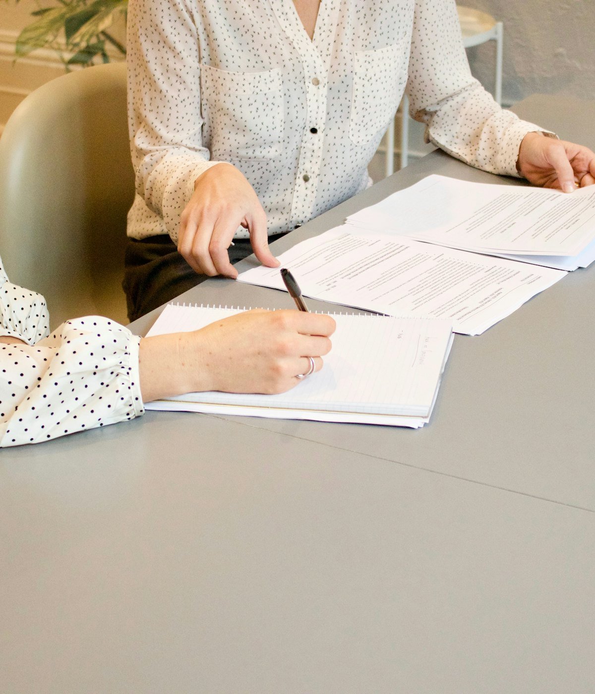 Advogada a acompanhar uma cliente na assinatura de documentos